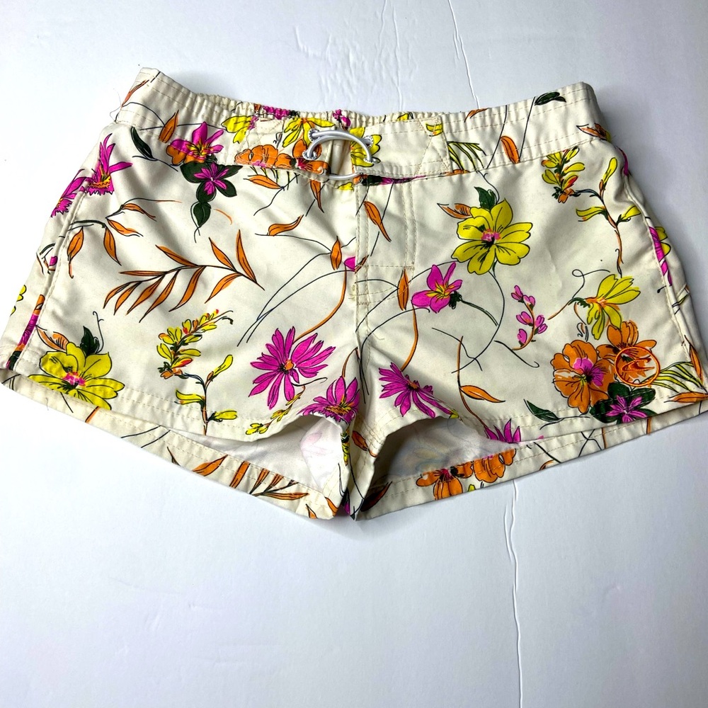 Flowery Girls swim trunks. Beige, pink, yellow, and orange.
